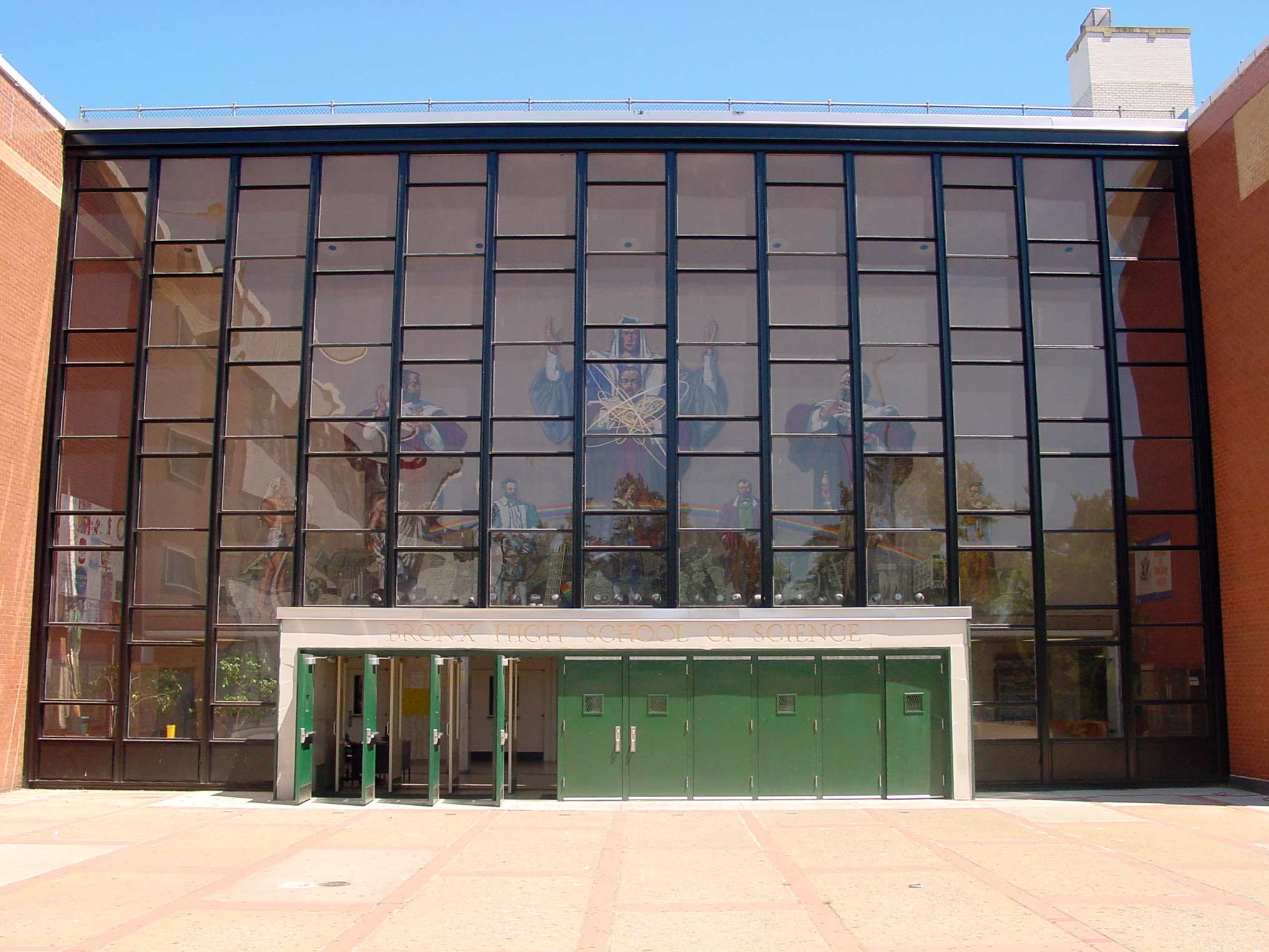 The entry to the high school. Beyond the doors and glass facade is the lobby and the giant mosaic.