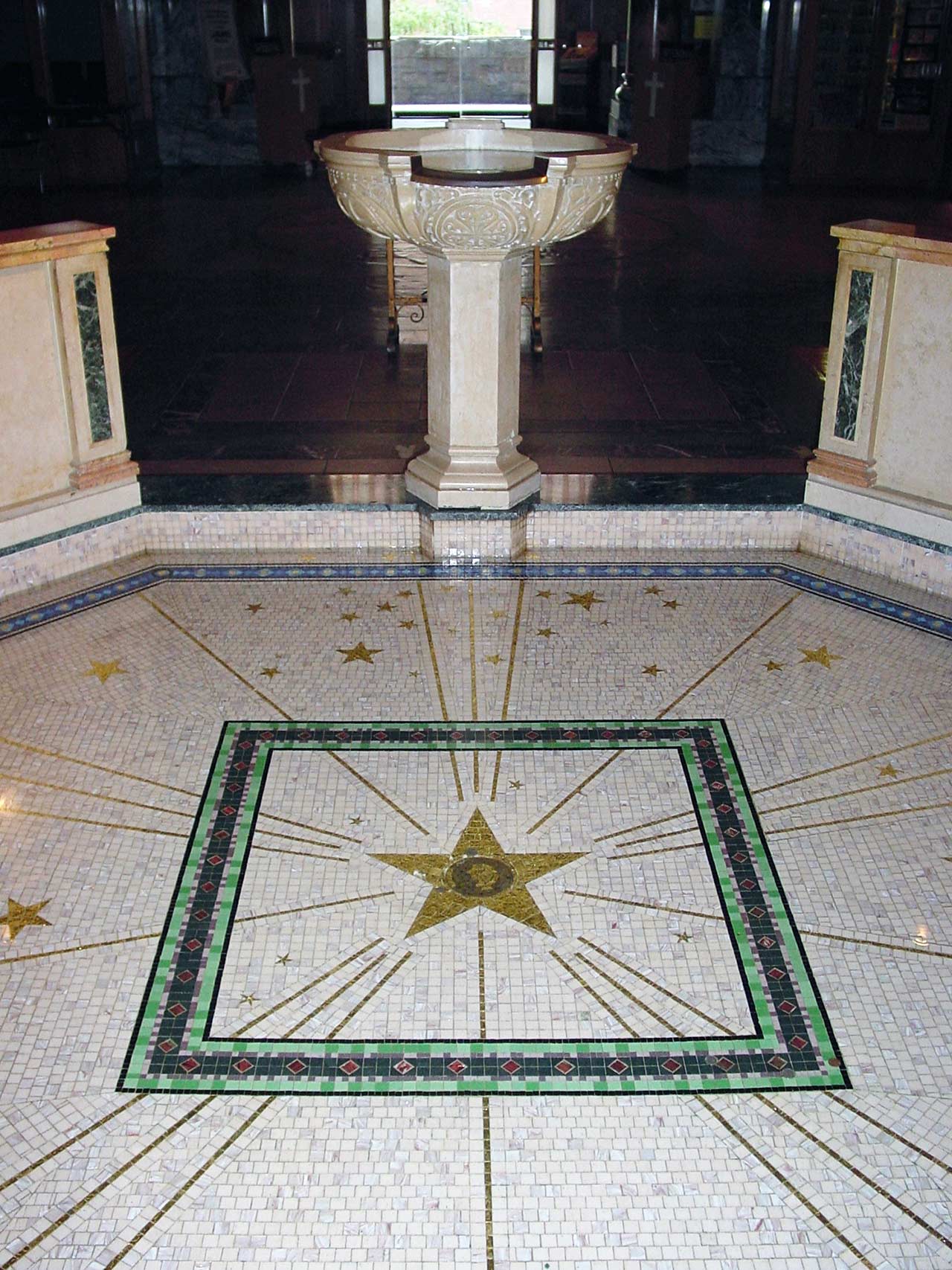 Tilework around the baptistry with stars in the floor.