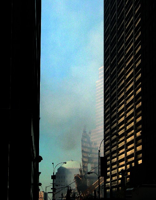 Looking down Liberty Street toward the skeletal steel facade of Tower 2 near sunset. One Liberty Plaza, the black, steel skyscraper is pictured on the right.
