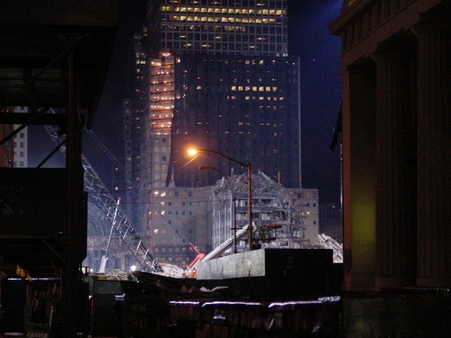 A nighttime view of the site, with cranes and lighting brought in for the cleanup process.