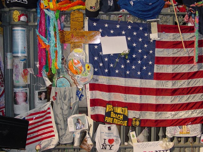 Pictured are the impromptu shrine of pictues, messages, and the American flag.