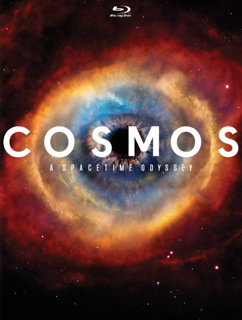 Cosmos: A Spacetime Odyssey cover, with the word “Cosmos” in front of an object that resembles the Helix Nebule, but with a pupal superimposed in its center.
