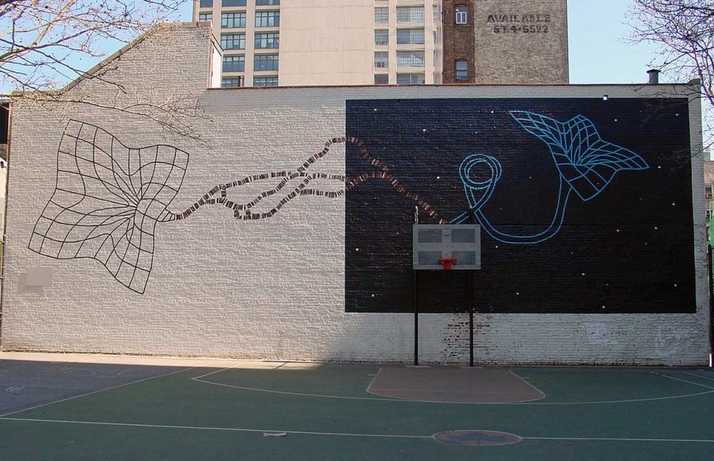 A city basketball court with a painting of a wire-frame objects meant to depict a black hole, connected by a strand of spacetime.