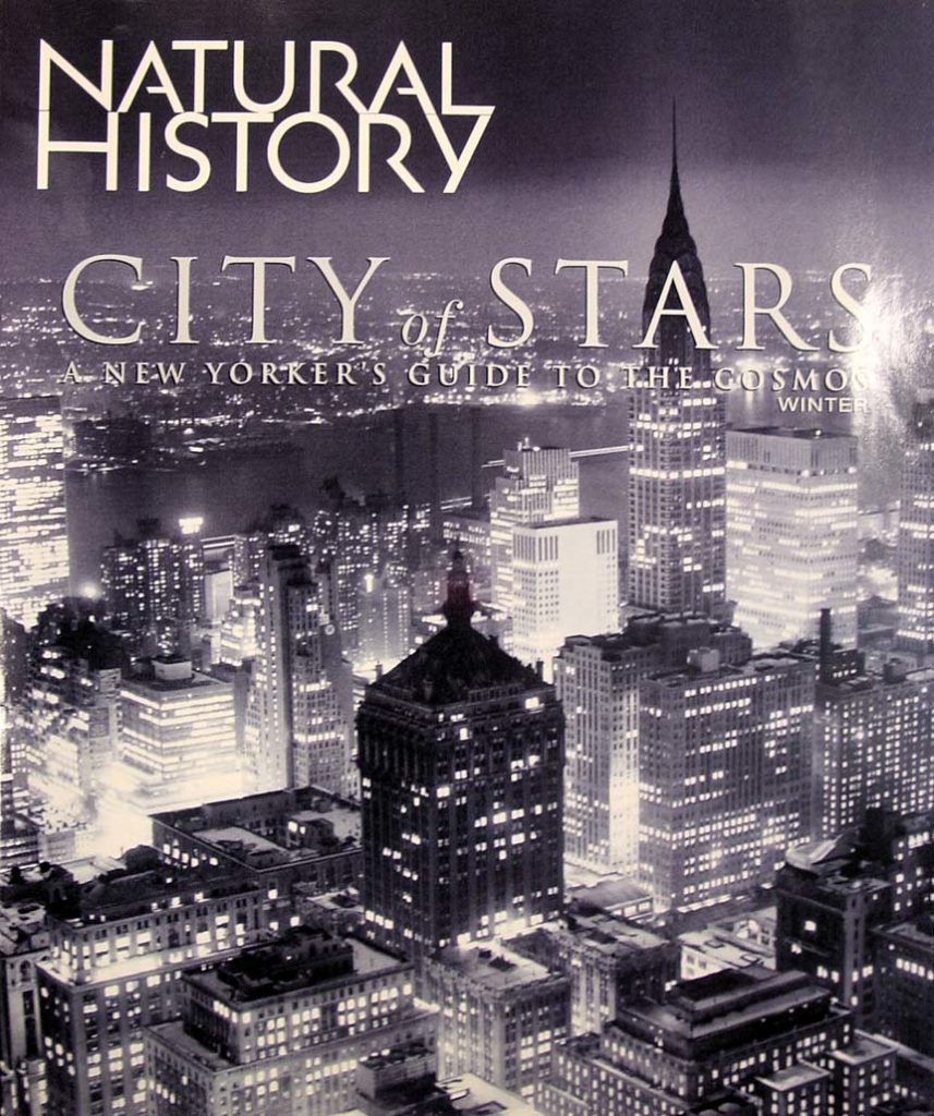 Cover of the Natural History magazine with the titles superimposed on a black and white photo of the city from a high locale looking down on the buildings.