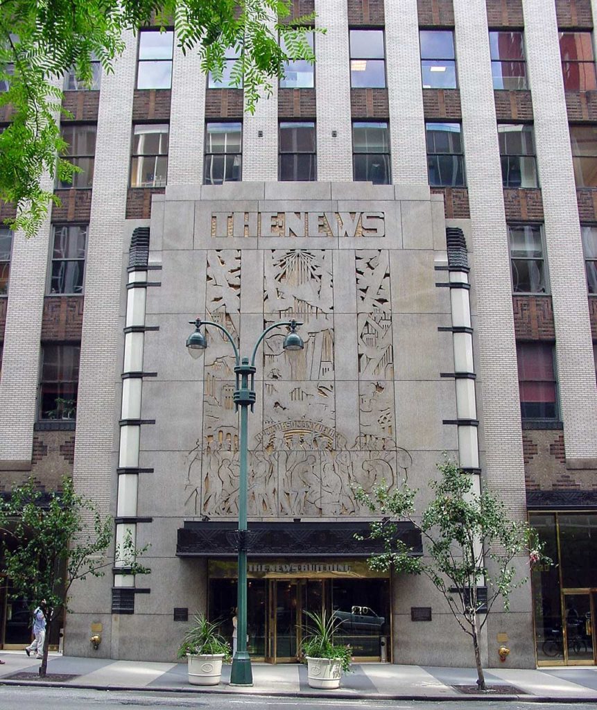 Photo of the facade of the Daily News Building, an Art Deco building with a carved, decorative artwork above the entry and the bold words, The News.