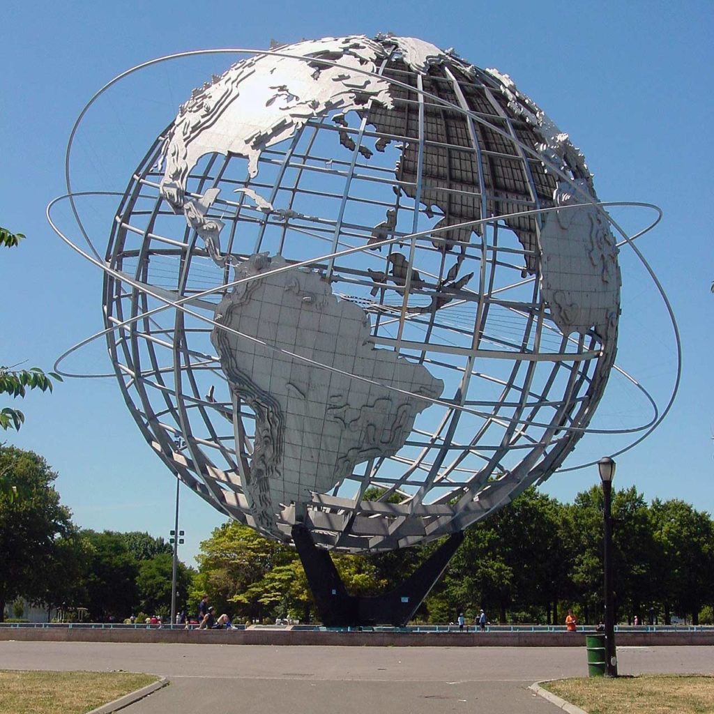 Photo of the Unisphere showing the entire Earth ringed by three representational orbits.