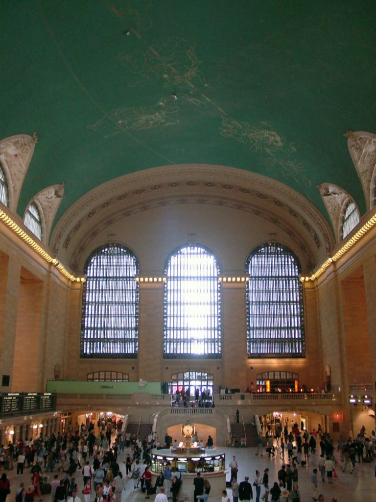 Photo inside Grand Central Terminal's main concourse, with its star-covered vaulted ceiling.
