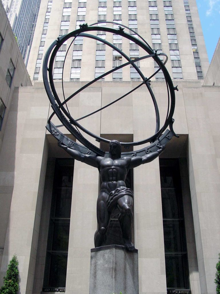The Atlas sculture in front of the buildings of Rockefeller Center. The muscular figure is holding up a huge armillary sphere: three rings with astronomical figures on them.