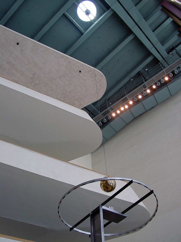 The pendulum inside the UN, looking up to the ceiling and its suspended measuring ring.